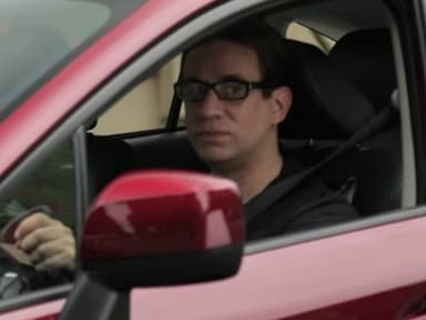 Driver in Red Subaru